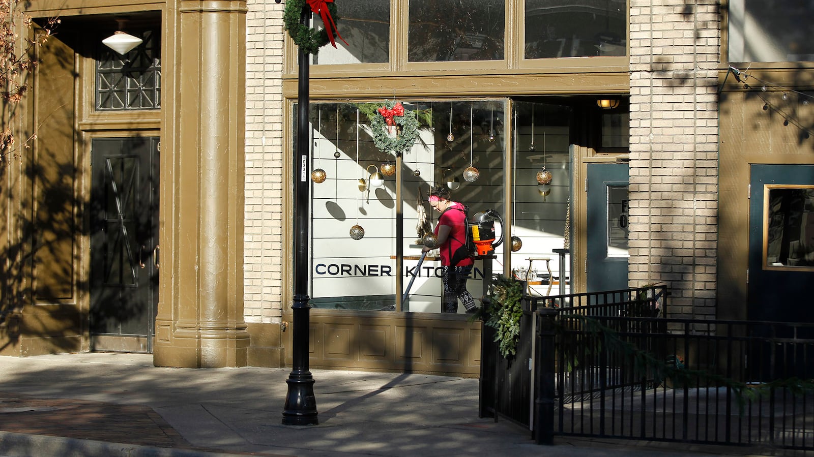 Liddy Vella vacuums the dining area of the Corner Kitchen at the corner of E. Fifth St. and Wayne Avenue.  TY GREENLEES / STAFF