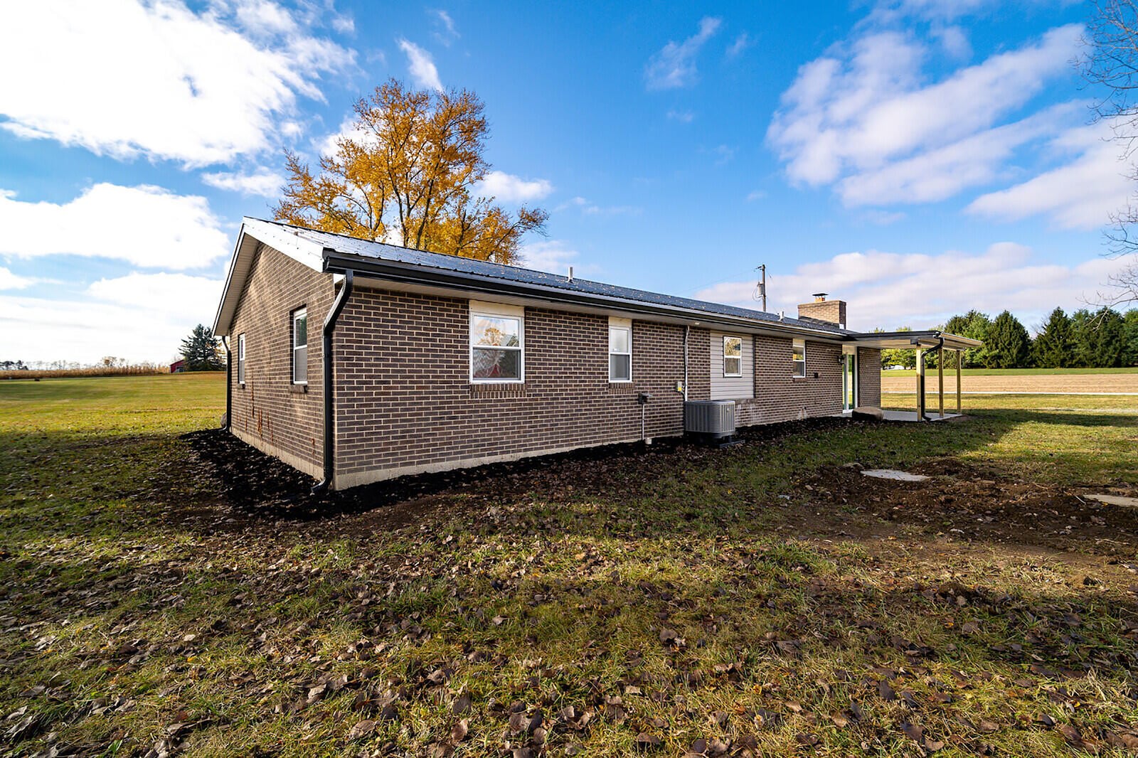 The rear has a covered concrete patio, and the property is completely open on all sides to the property lines.