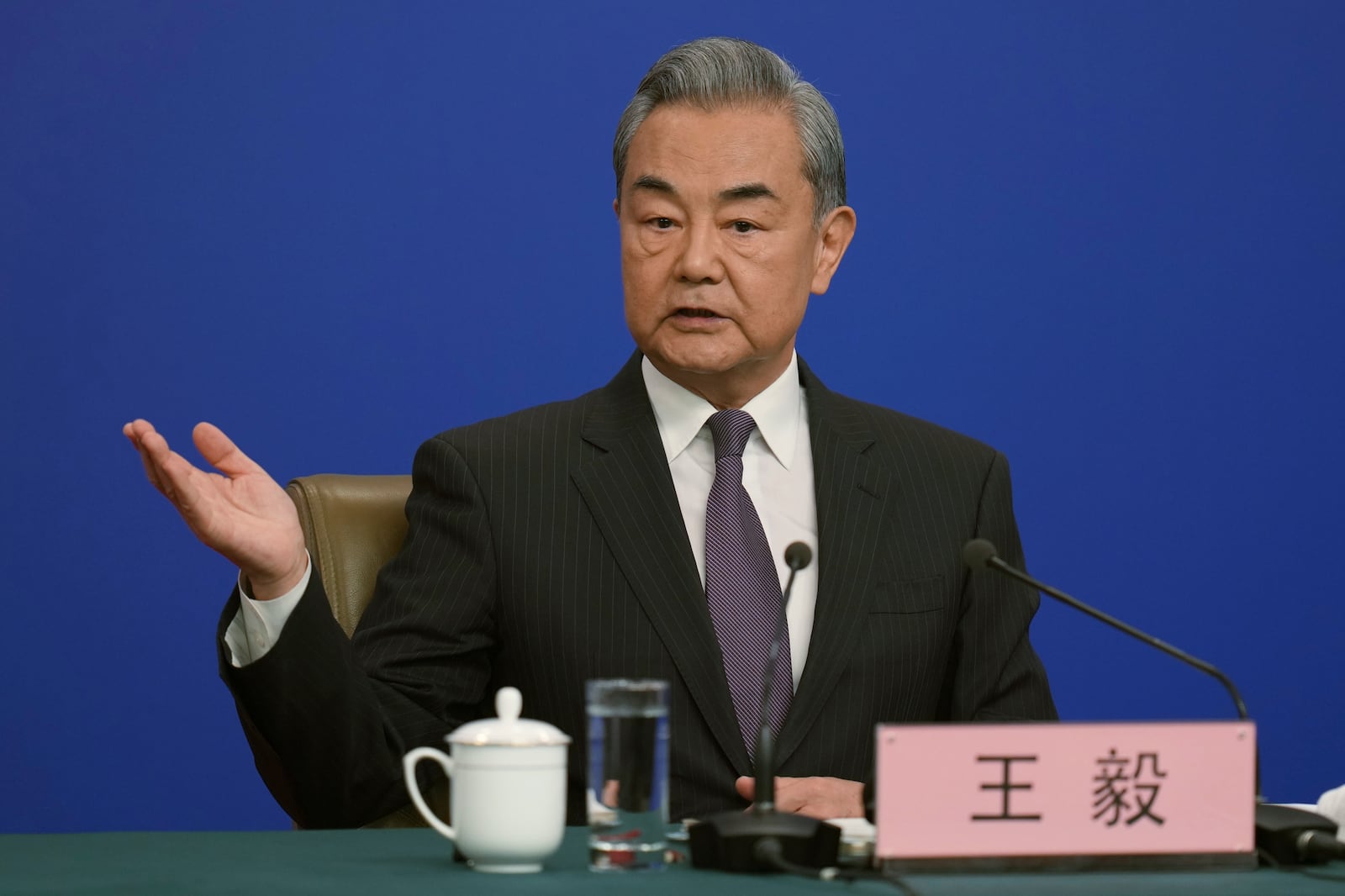 Chinese Foreign Minister Wang Yi arrives for a press conference on the sideline of the National People's Congress in Beijing, Friday, March 7, 2025. (AP Photo/Ng Han Guan)