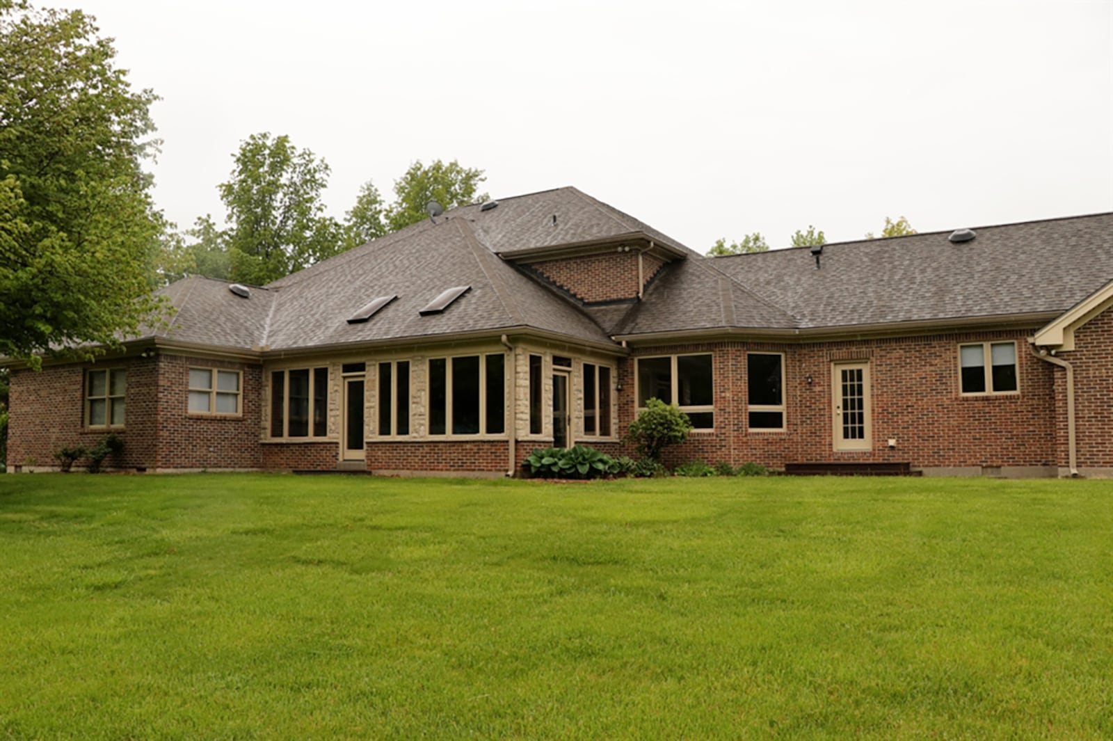 The enclosed patio has terra-cotta tile flooring, tongue-and-groove wood ceiling with 2 skylights and ceiling paddle fans. The patio is accessible through two sets of patio doors from the family room and a single door off the first-floor main bedroom. CONTRIBUTED PHOTO BY KATHY TYLER