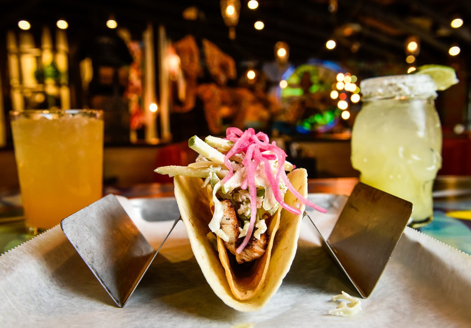 Agave & Rye's new restaurant on Troy's Public Square has set a projected opening date of Nov. 15, 2020. This photo was taken at the Agave & Rye location in Liberty Center in Liberty Township. It shows "The Epic Taco" with slab pork belly, apple slaw, pickled onion and rattlesnake sauce served here with Bourbon Peach Punch, left, and OG Rita, right. File photo by NICK GRAHAM/STAFF