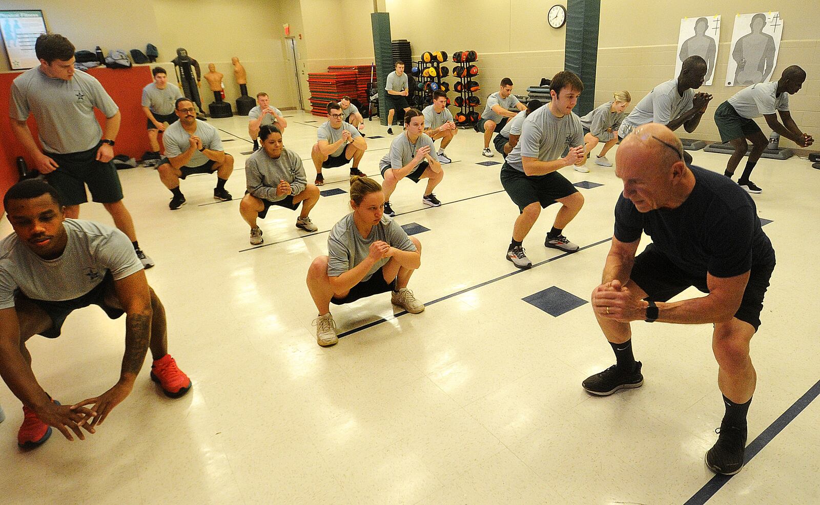 Police cadets at Sinclair Community College perform air squats as part of morning physical training, Thursday, Jan. 11, 2024. MARSHALL GORBY\STAFF