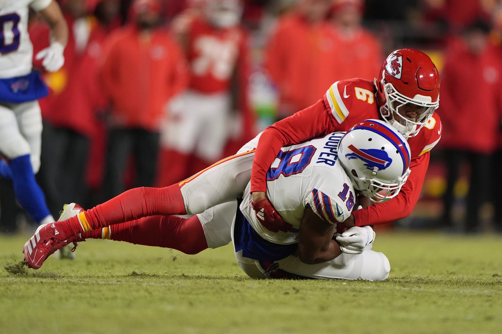 Buffalo Bills wide receiver Amari Cooper (18) is tackled by Kansas City Chiefs safety Bryan Cook (6) after catching a pass during the first half of the AFC Championship NFL football game, Sunday, Jan. 26, 2025, in Kansas City, Mo. (AP Photo/Charlie Riedel)