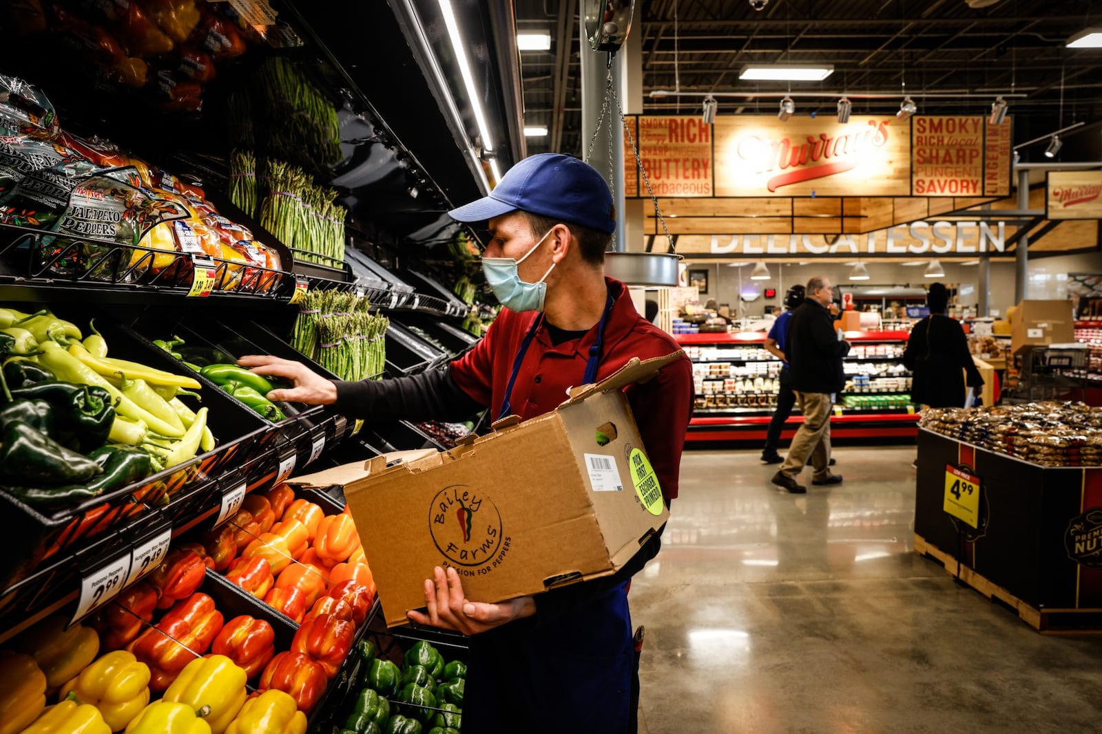 Kroger employee, James Severs stocks cooler shelves at the new Kroger in Springboro on Wednesday Oct. 20, 2021. JIM NOELKER/STAFF