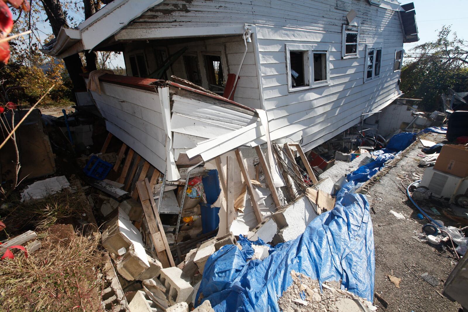 Though his Harrison Twp. house was lifted and moved entirely from its foundation, Timothy Walker went back inside after the tornado to retrieve his daughter’s favorite doll. CHRIS STEWART / STAFF