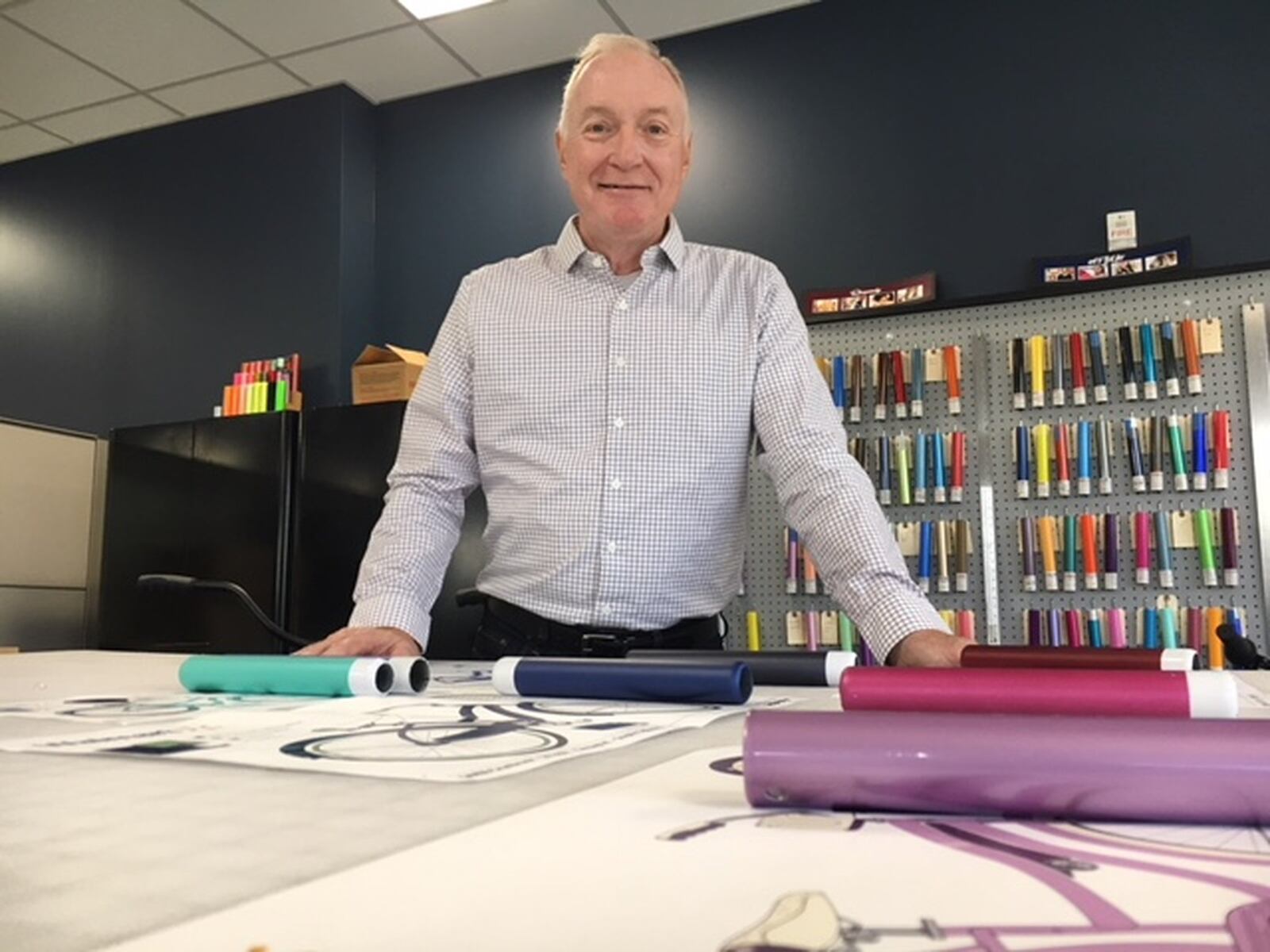 Bill Smith, president and chief executive of Huffy, stands amid new designs and color samples for upcoming Huffy bicycles. The company has added 20 percent to its local workforce since January, with some 130 people now working at the company’s new Gander Creek Drive offices. THOMAS GNAU/STAFF