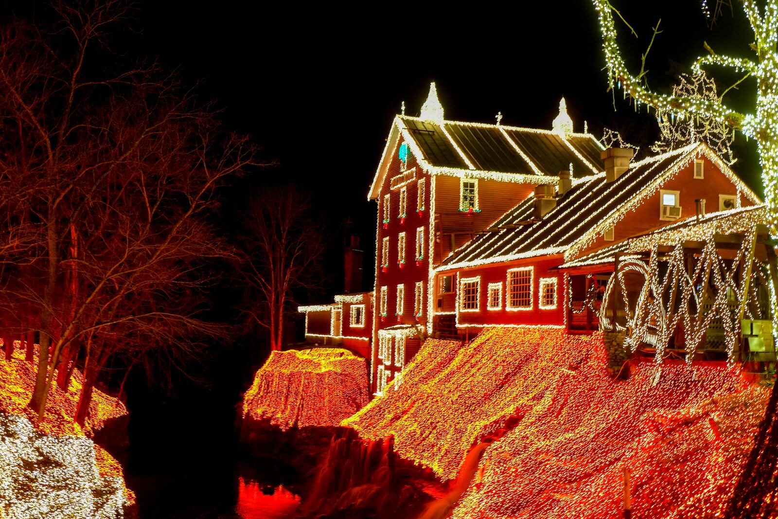 Visitors take in the Legendary Lights at the historic Clifton Mill, just outside Yellow Springs, Friday, Dec. 2, 2022. The mill, built in 1802 and still a working, has become a Miami Valley institution around the holidays. GREG LYNCH / STAFF