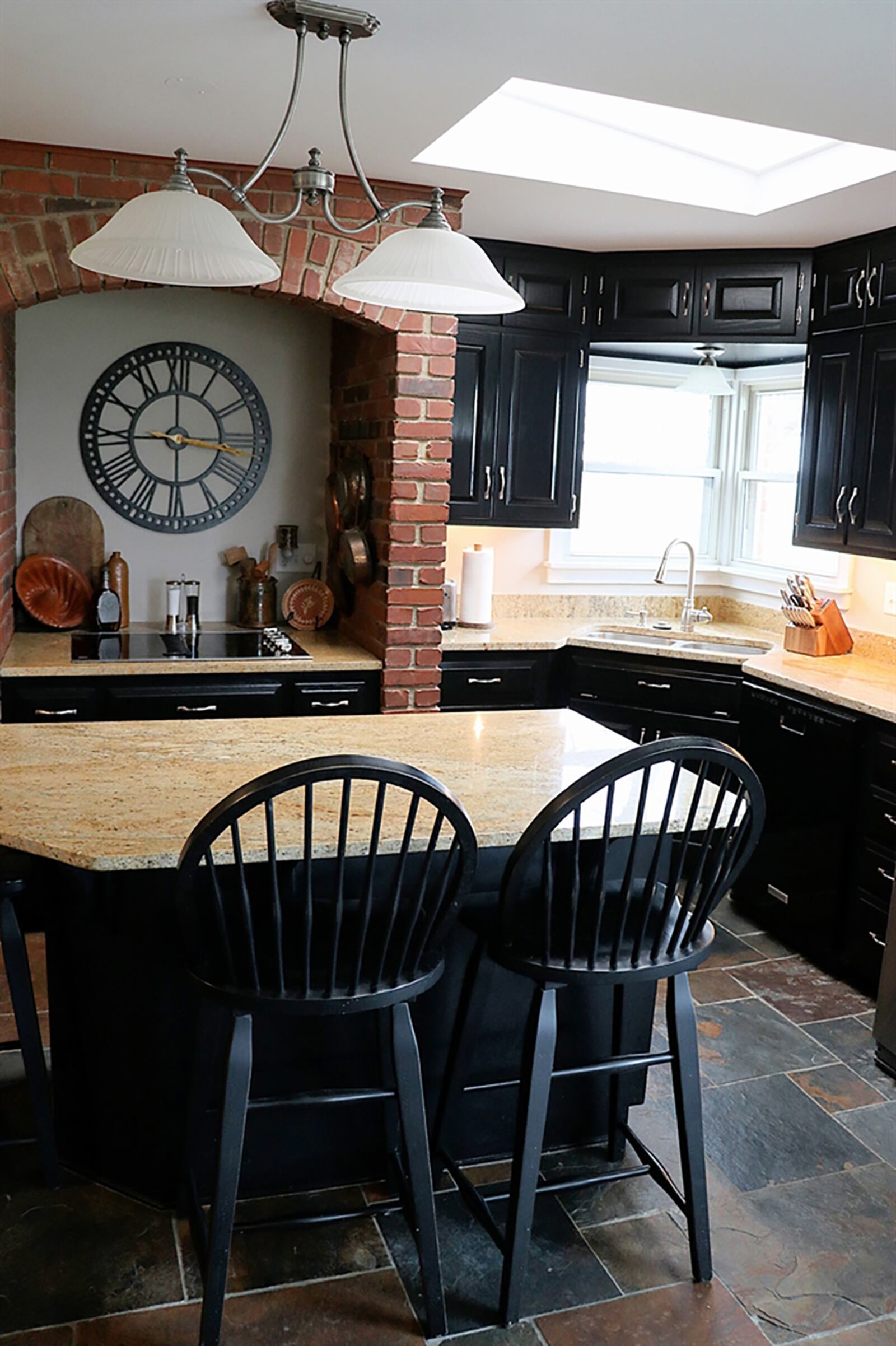 The kitchen includes a wet bar and coffee station that wraps into a planning desk. On the opposite wall are pantry cabinets with pullout shelves. An island with granite top is more of a built-in breakfast table beneath a skylight and tucked back with a picture window is a breakfast room. CONTRIBUTED PHOTO BY KATHY TYLER