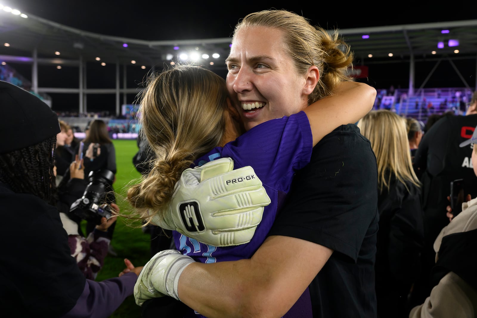 Orlando Pride goalkeeper Anna Moorhouse, right, hugs Pride defender Carrie Lawrence after they defeated the Washington Spirit in the NWSL championship soccer game at CPKC Stadium, Saturday, Nov. 23, 2024, in Kansas City, Mo. (AP Photo/Reed Hoffmann)