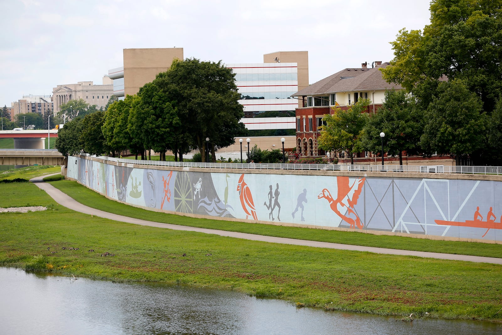 The River Run Mural spans 950 feet next to the Great Miami River across from RiverScape Metro Park. Designed by artist Amy Deal it was painted on the flood wall by artists from K12 Gallery. LISA POWELL / STAFF