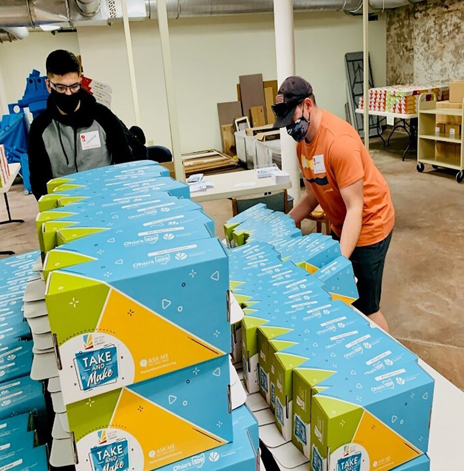 Senior Airman Alexander Otto (left) and Tech Sgt. Stephen Parson organize assembled kits. The “Take and Make” kits the team packed and arranged support Dayton Metro Library’s May effort to teach children and teens about clean water and rivers. CONTRIBUTED PHOTO