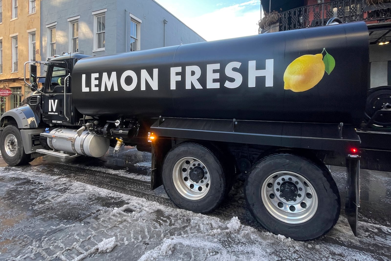 The flusher truck - normally deployed to spray lemon-scented fragrance around the pungent French Quarter - is used to clear ice Thursday, Jan. 23, 2025, in New Orleans after a rare winter blizzard. (Sidney Torres/IV Waste via AP)