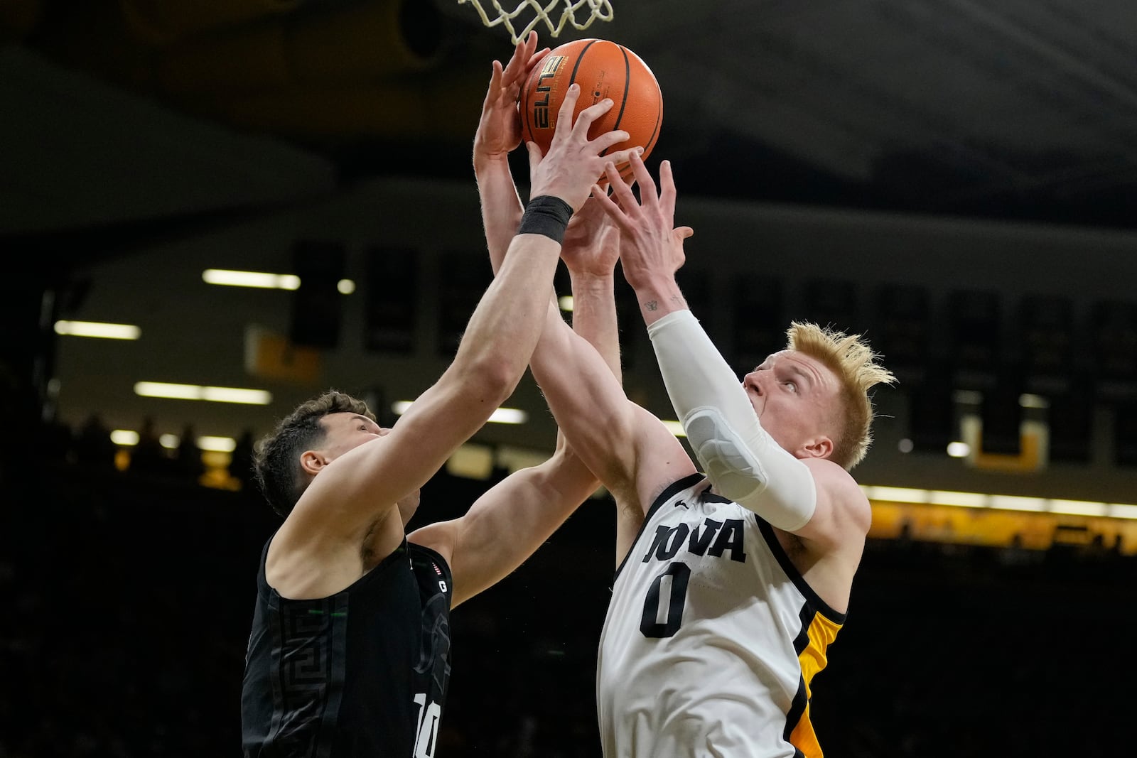 Michigan State center Szymon Zapala, left, fights for a rebound with Iowa forward Even Brauns (0) during the first half of an NCAA college basketball game, Thursday, March 6, 2025, in Iowa City, Iowa. (AP Photo/Charlie Neibergall)