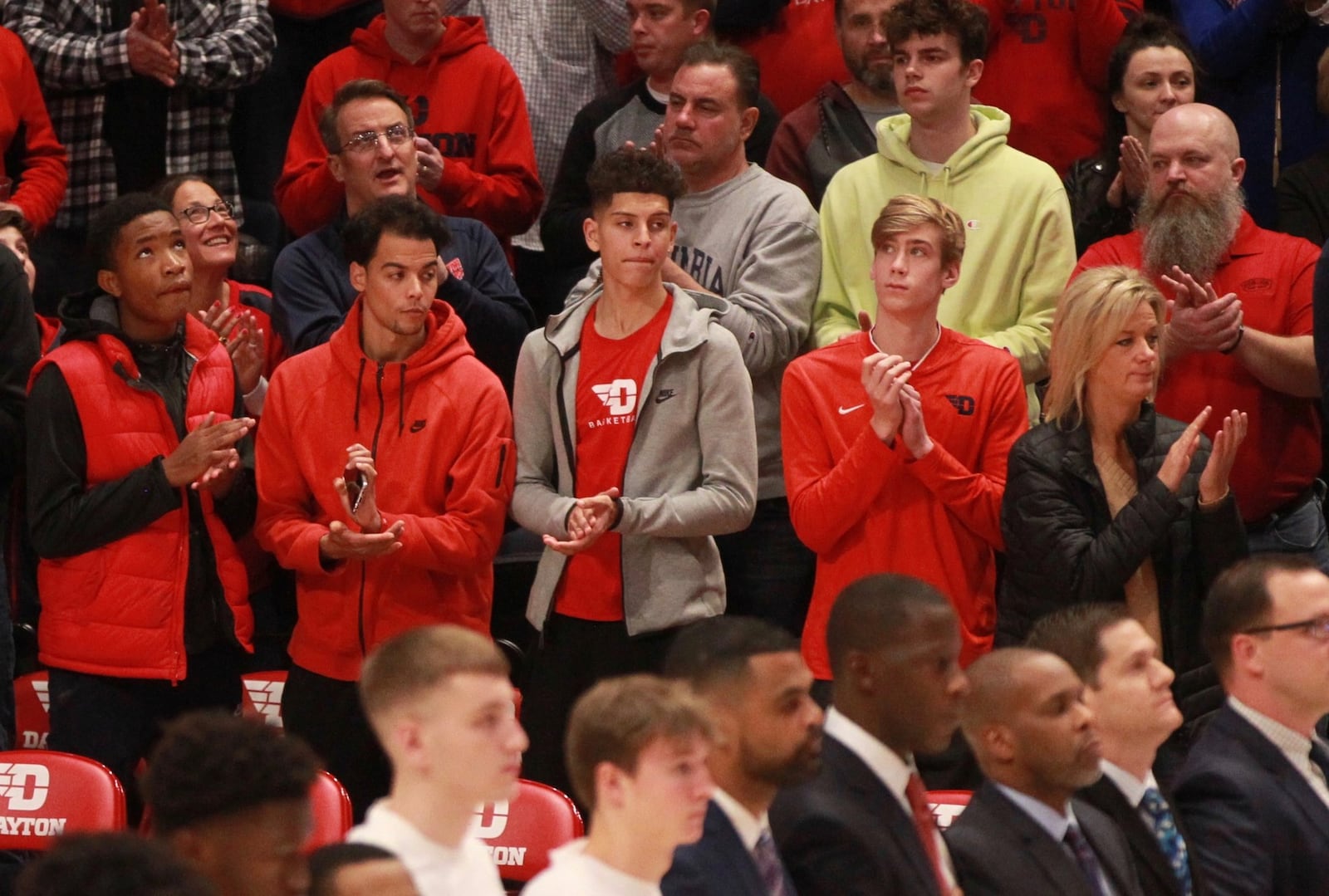 Koby Brea, center, stands behind the Dayton bench next to Lukas Frazier, second from right, during a game against Indiana State on Nov. 9, 2019, at UD Arena. David Jablonski/Staff