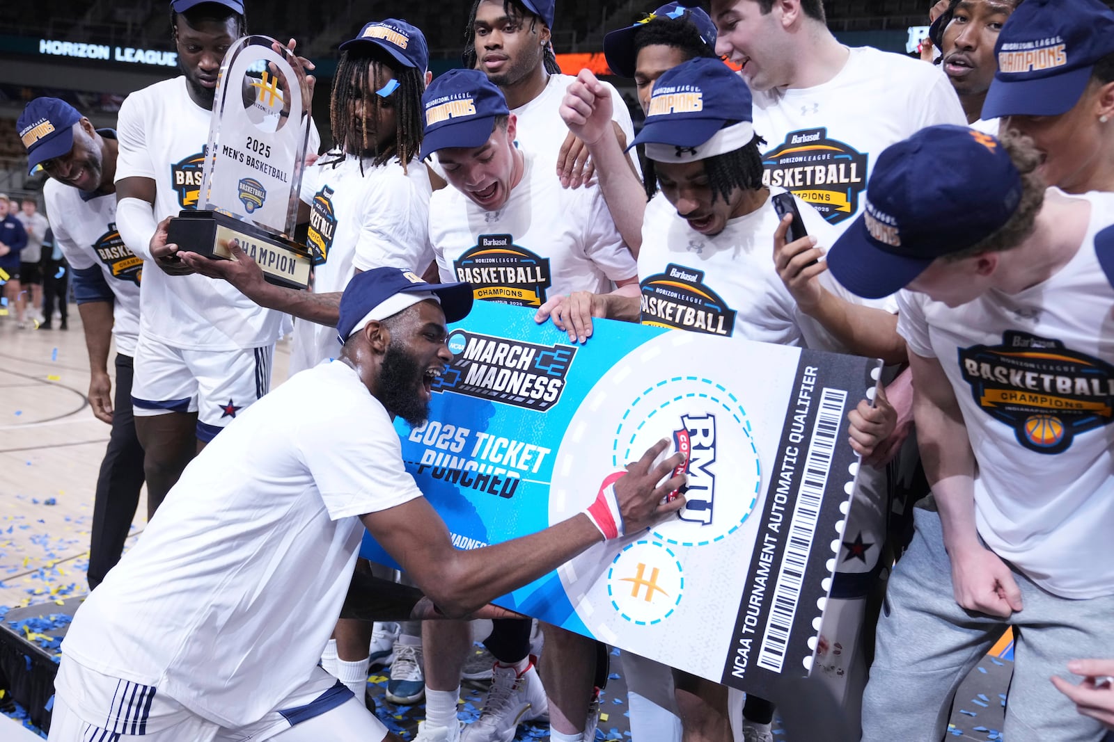 Robert Morris guard Amarion Dickerson (3) "punches" the team's ticket to the NCAA tournament after defeating Youngstown State in an NCAA college basketball game in the championship of the Horizon League tournament in Indianapolis, Tuesday, March 11, 2025. (AP Photo/Michael Conroy)