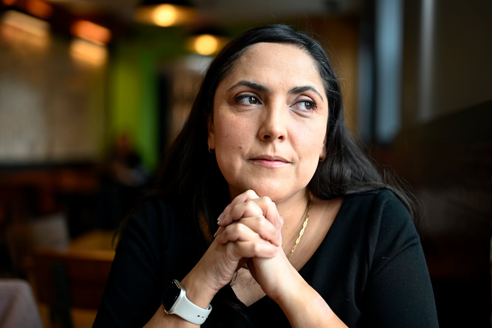 Jenn Kauffman, a semi-finalist for the 2025 Presidential Management Fellows program that was canceled due to budget cuts by DOGE sits in her neighborhood cafe on Thursday, March. 6, 2025, in Washington. (AP Photo/John McDonnell)