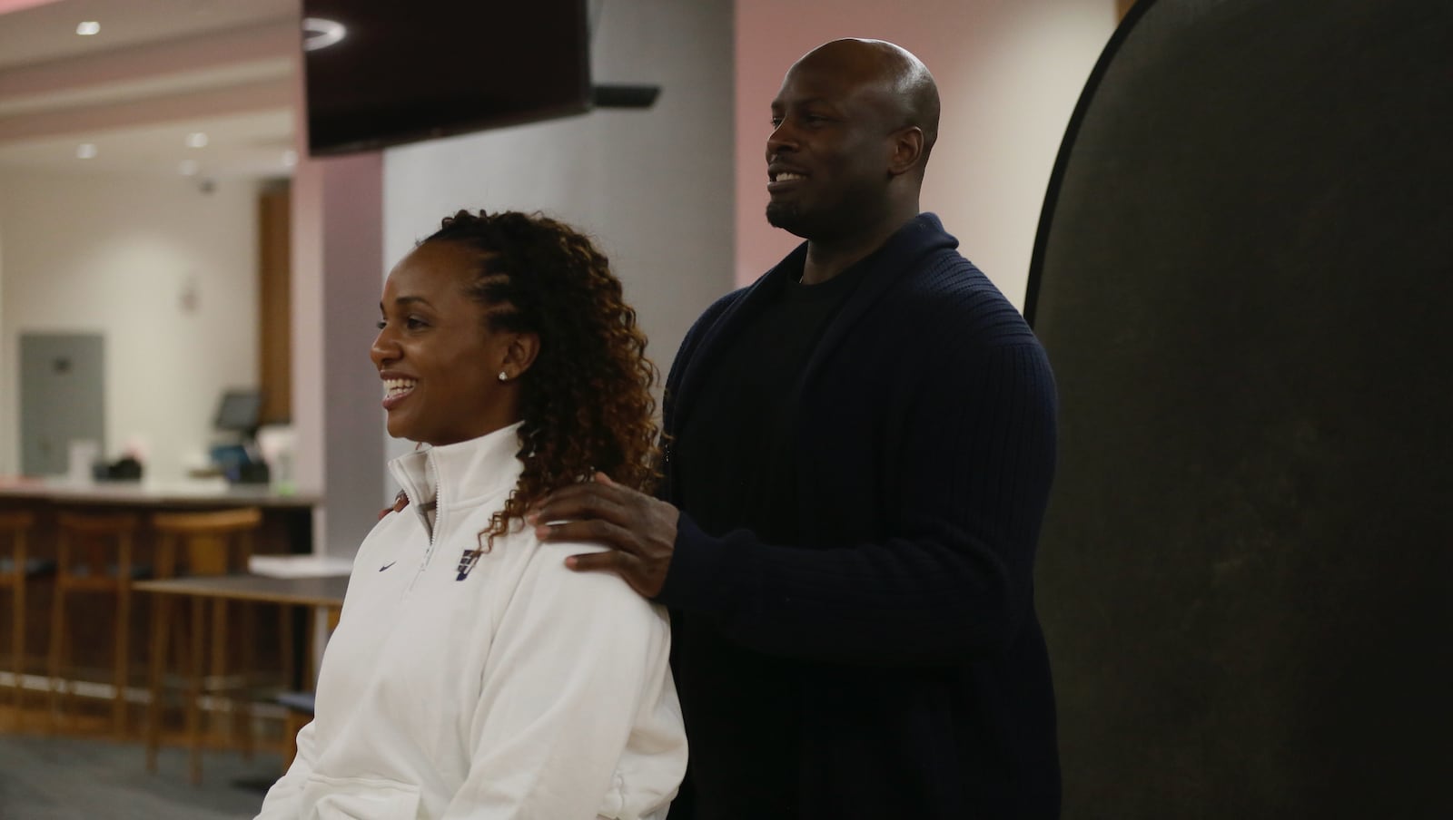 Tamika Williams-Jeter poses for a photo with her husband Richard Jeter after being introduced as the new head women's basketball coach at Dayton on Monday, March 28, 2022, at UD Arena. David Jablonski/Staff