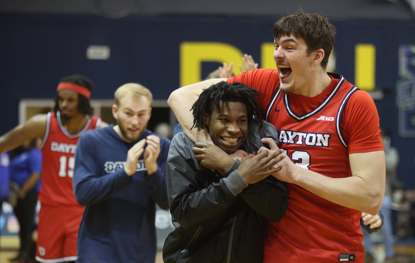 Dayton's Isaac Jack, right, and Malachi Smith leave the court after a victory against La Salle on Tuesday, Jan. 23, 2024, at Tom Gola Arena in Philadelphia. David Jablonski/Staff