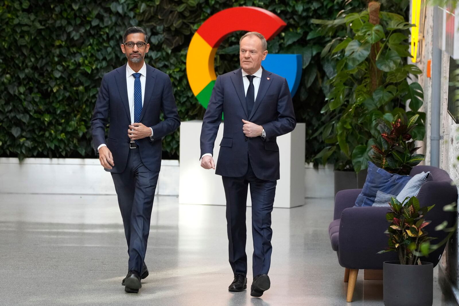 Google and Alphabet CEO Sundar Pichai, left, and Poland's Prime Minister Donald Tusk, right, meet for talks about involving artificial intelligence into the energy and cybersecurity sectors in Poland, at the Google Startup Campus in Warsaw, Poland, on Thursday, Feb. 13, 2025. (AP Photo/Czarek Sokolowski)