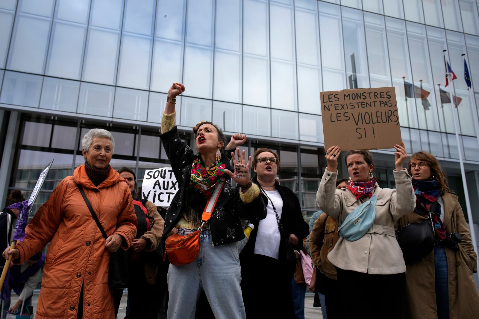 FILE - Women's rights activists demonstrate outside the Paris palace of justice as French actor Gérard Depardieu, who is facing trial for the alleged sexual assaults of two women on a film set in 2021, won't appear before a criminal court, Monday, Oct. 28, 2024 in Paris. (AP Photo/Louise Delmotte, File)