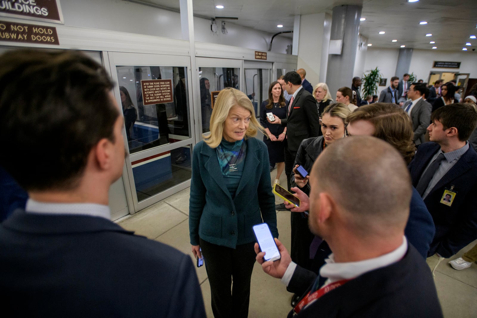 Sen. Lisa Murkowski, R-Alaska, talks with reporters as she makes her way through the Senate subway at the Capitol, Thursday, Jan. 23, 2025, in Washington. (AP Photo/Rod Lamkey, Jr.)