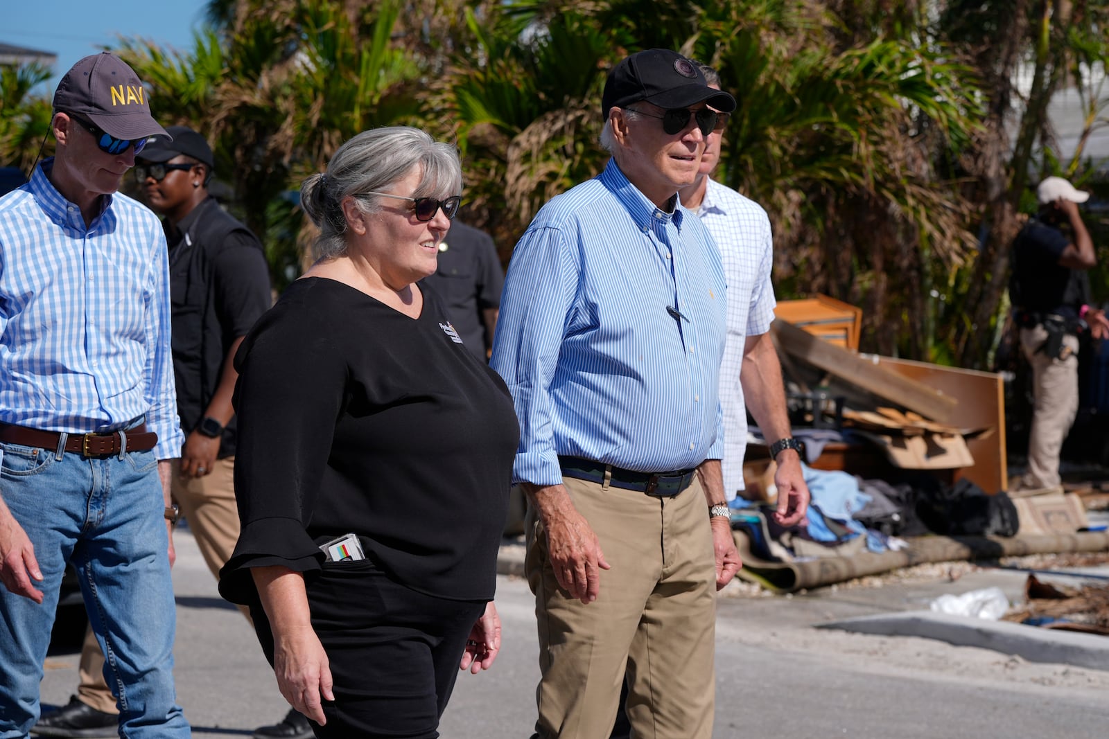 President Joe Biden, right, walks during a tour of areas affected by Hurricane Milton in St. Pete Beach, Fla., following an aerial tour, Sunday, Oct. 13, 2024. (AP Photo/Manuel Balce Ceneta)