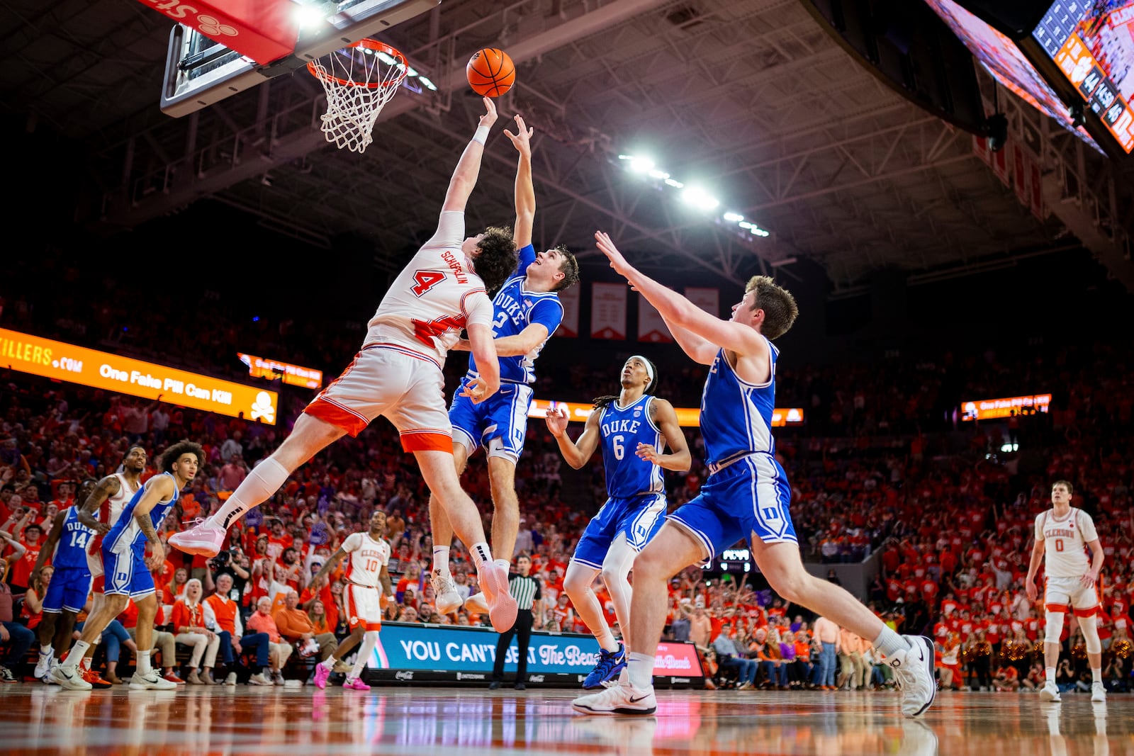 Clemson forward Ian Schieffelin (4) and Duke guard Cooper Flagg (2) go for a rebound during the second half of an NCAA college basketball game on Saturday, Feb. 8, 2025, in Clemson, S.C. (AP Photo/Scott Kinser)