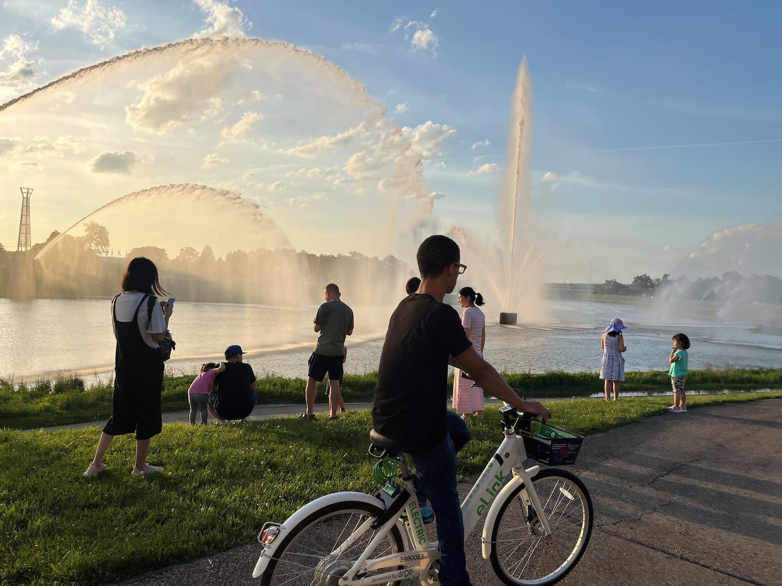 A man rides on one of Link's electric-assisted bicycles by the fountains at RiverScape MetroPark. CORNELIUS FROLIK / STAFF