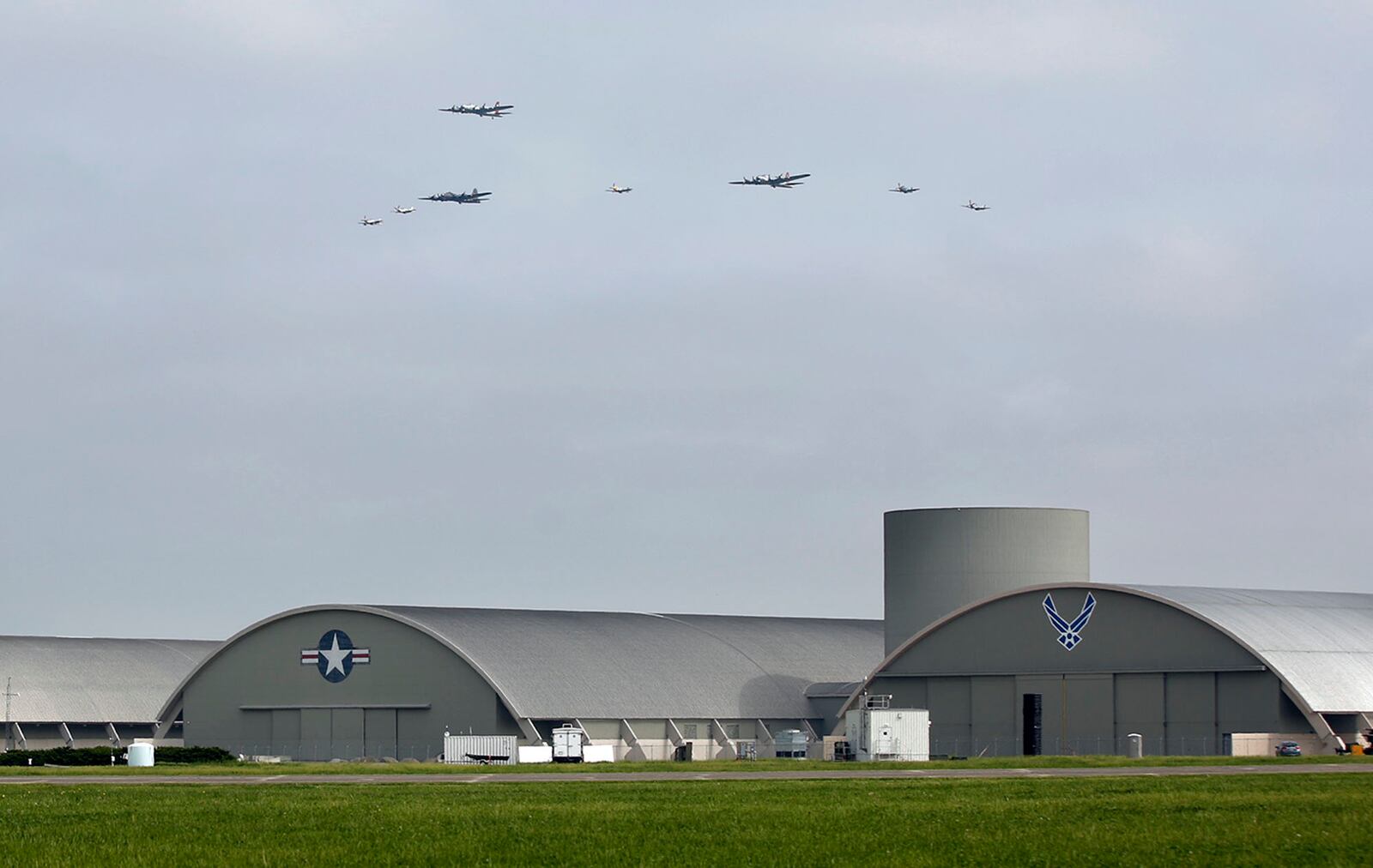 World War II era aircraft including three B-17 bombers and 5 P-51 Mustangs flew over the National Museum of the U.S. Air Force on Wednesday as part of the festivities included in the opening of the Memphis Belle exhibit.   TY GREENLEES / STAFF