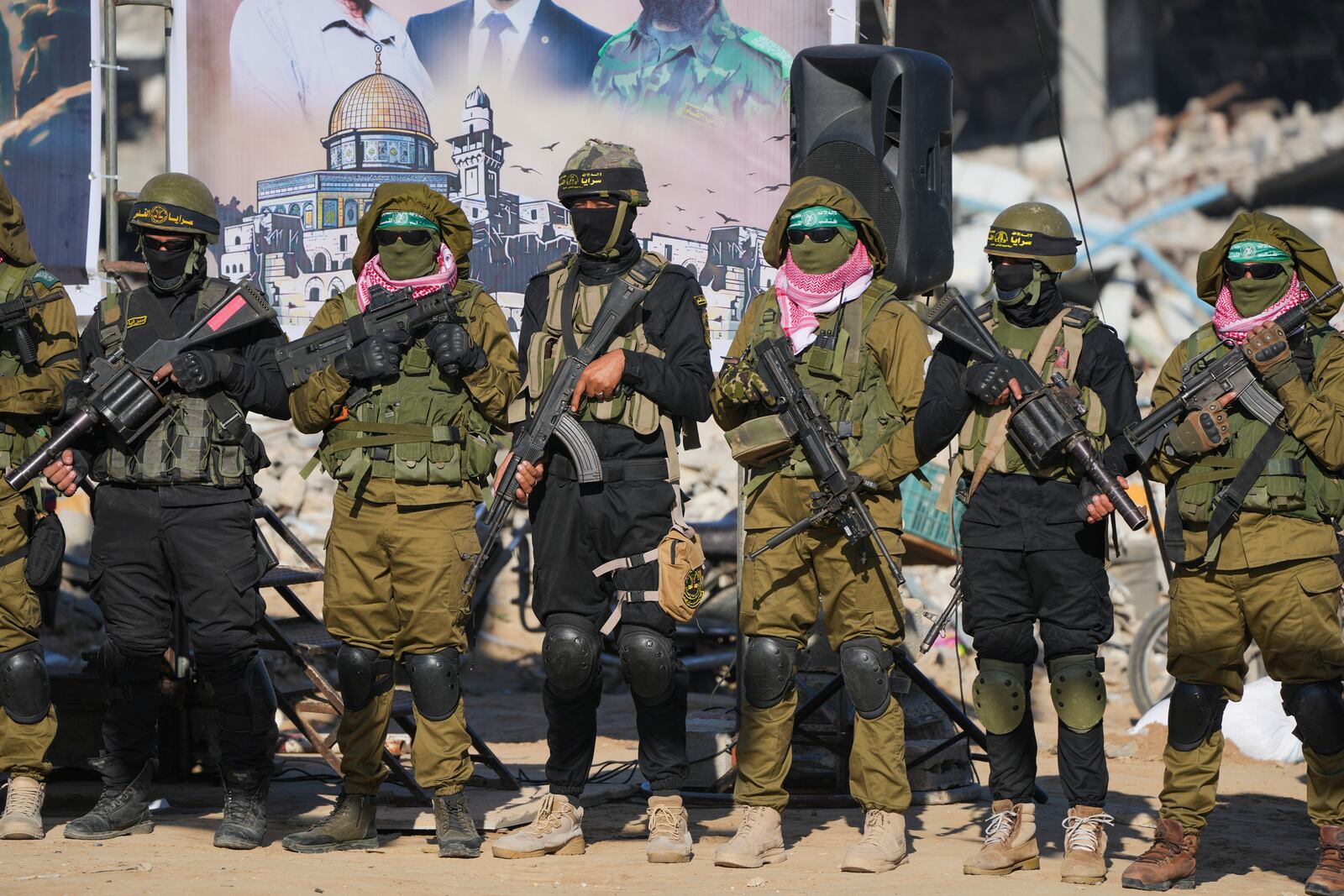 Hamas and Islamic Jihad fighters stand in formation ahead of a hostages' release in Khan Younis, Gaza Strip, Saturday, Feb. 15, 2025. (AP Photo/Abdel Kareem Hana)