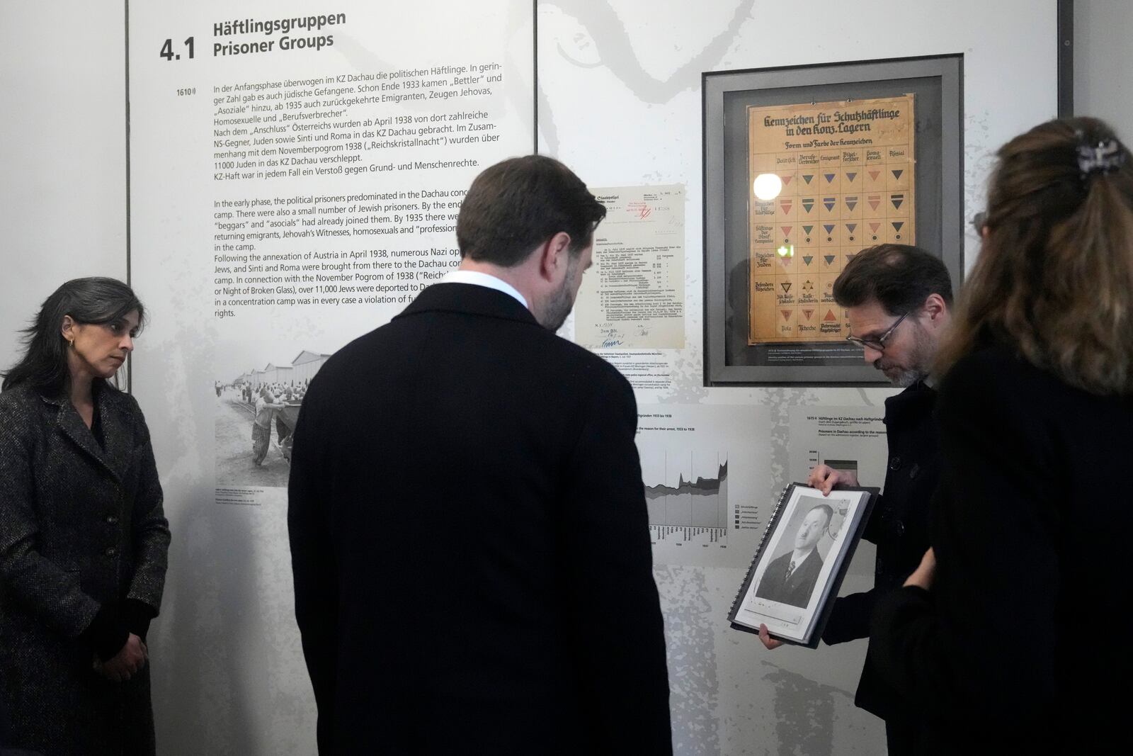 U.S. Vice President JD Vance and second lady Usha Vance are shown a picture of a prisoner during a visit to the Dachau Concentration Camp Memorial Site outside Munich, Germany, Thursday, Feb. 13, 2025. (AP Photo/Matthias Schrader)