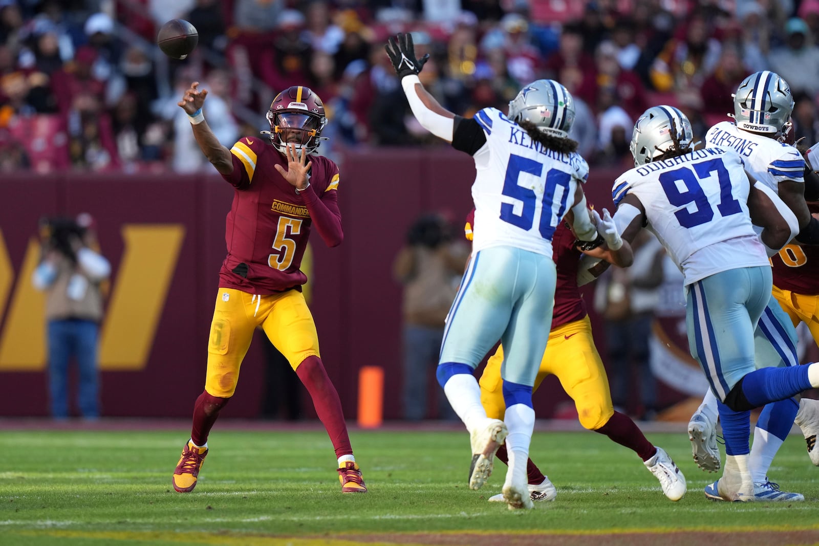 Washington Commanders quarterback Jayden Daniels (5) passes during the second half of an NFL football game against the Dallas Cowboys, Sunday, Nov. 24, 2024, in Landover, Md. (AP Photo/Stephanie Scarbrough)