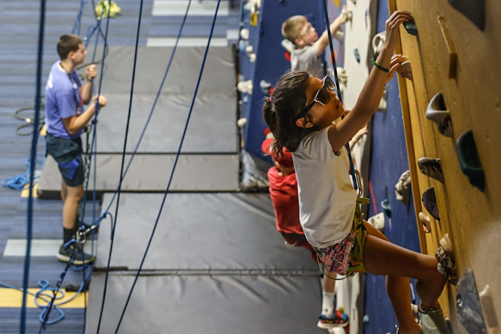 Washington Township summer camp member, Avery Mendoza climbs the wall at the RecPlex on Wednesday July5, 2023. The RecPlex has been upgraded including a refaced climbing wall. JIM NOELKER/STAFF