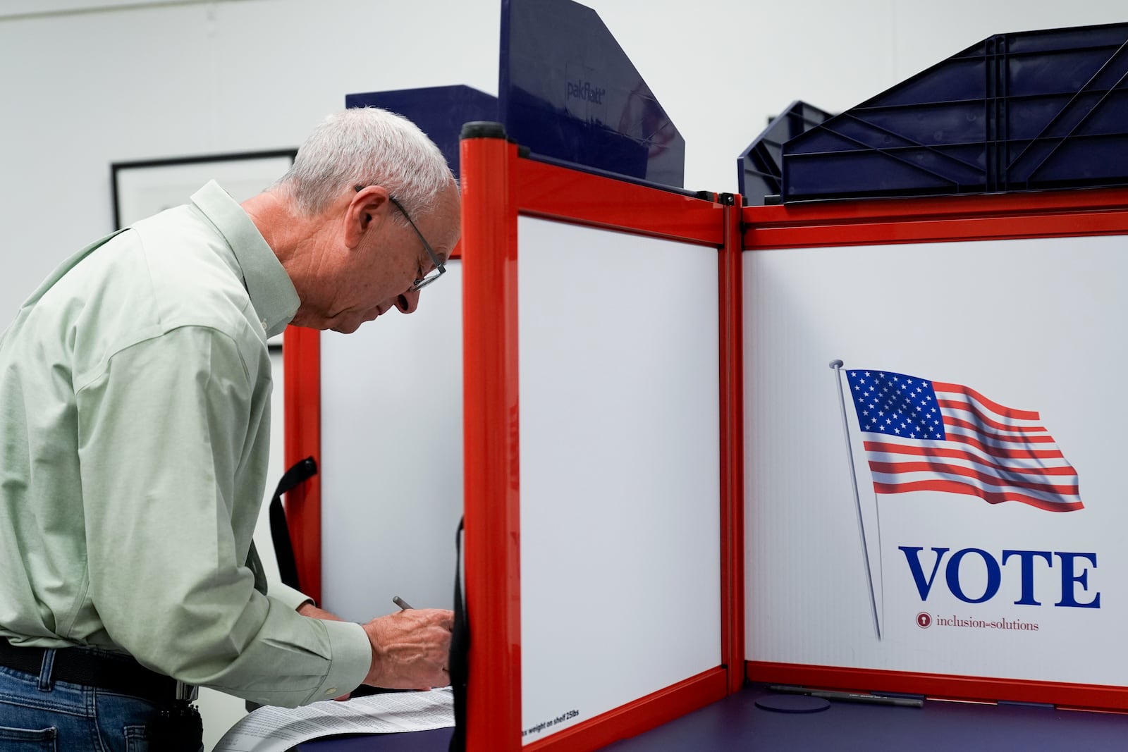 A person marks their ballot at the polling place at Tysons-Pimmit Regional Library in Falls Church, Va., Thursday, Oct. 31, 2024. (AP Photo/Stephanie Scarbrough)