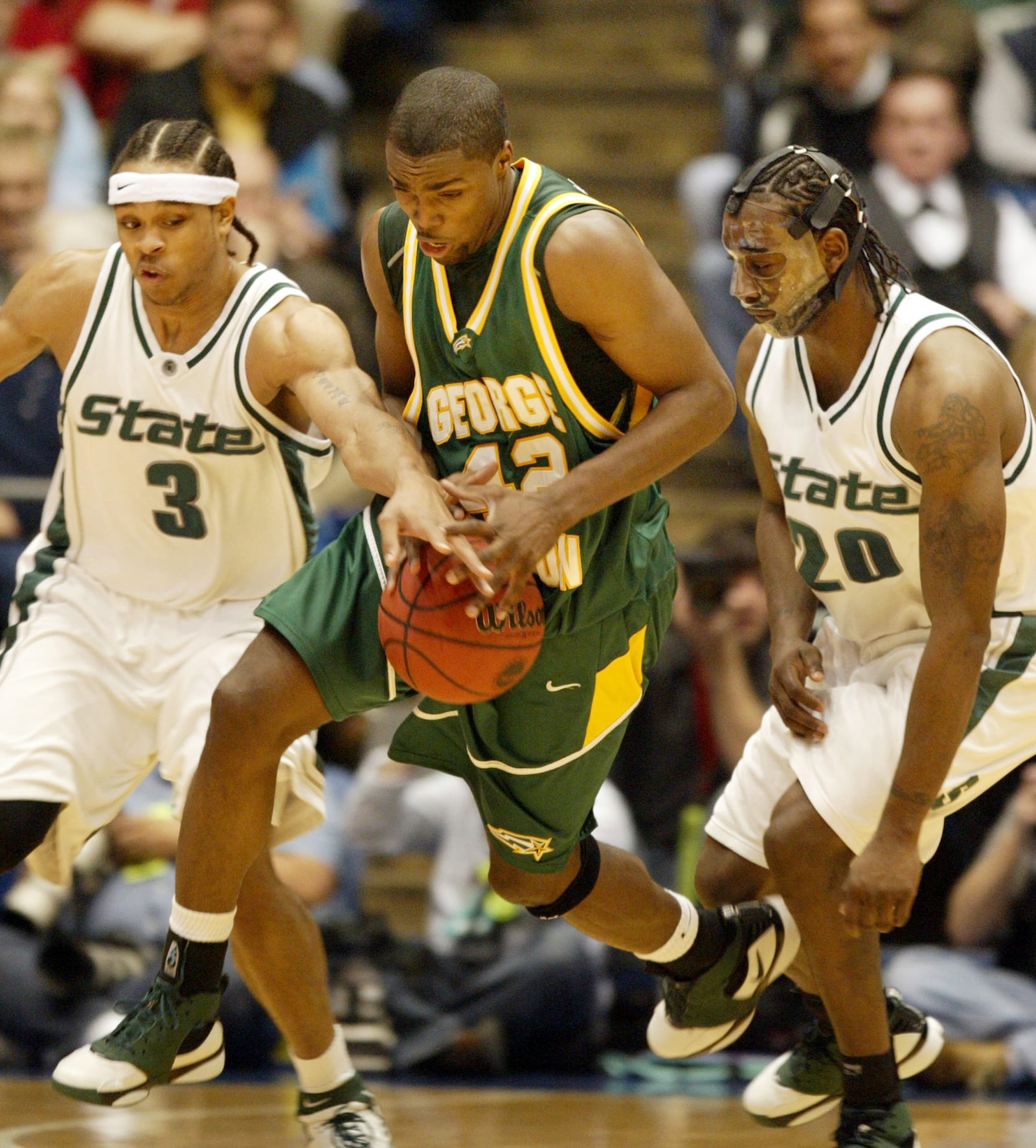 Michigan State's Shannon Brown (3) and Matt Trannon (20) flank George Mason's Folarin Campbell in the first half of their NCAA tourney game in 2006 at UD Arena. Campbell led George Mason with 21 points the their 75-65 victory. CHRIS STEWART/DAYTON DAILY NEWS