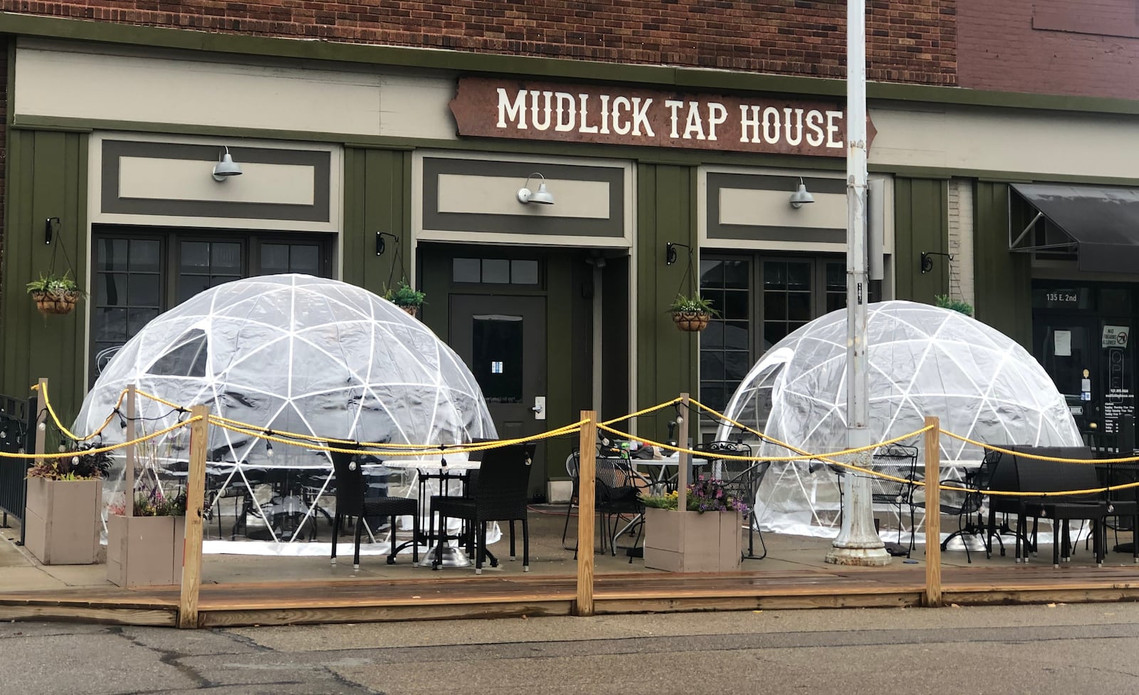 Mudlick Tap House in downtown Dayton installed plastic igloos on its patio to keep guests safe during the coronavirus pandemic. CORNELIUS FROLIK / STAFF FILE