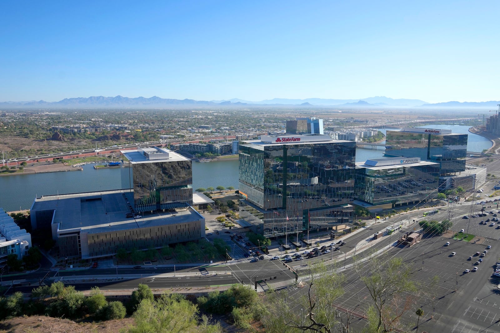 Business offices occupy the south side of Tempe Town Lake, Tuesday, Sept. 24, 2024, in Tempe, Ariz. (AP Photo/Ross D. Franklin)