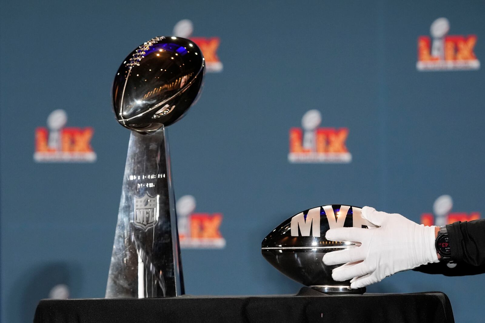 The Pete Rozelle MVP trophy and the Vince Lombardi trophy are placed before the start of a news conference the morning after the NFL Super Bowl 59 football game between the Philadelphia Eagles and the Kansas City Chiefs, Monday, Feb. 10, 2025, in New Orleans. (AP Photo/Gerald Herbert)