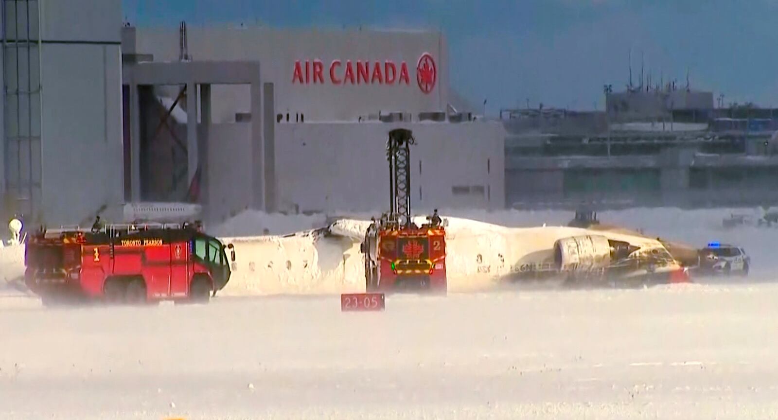 This image taken from video provided by CTV shows emergency crews responding at Toronto Pearson Airport after a plane crash, Monday, Feb. 17, 2025. (CTV via AP)