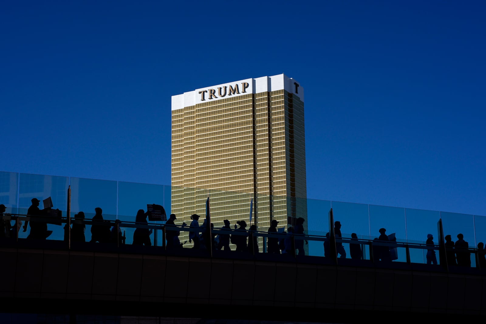 Demonstrators march to protest against the Trump administration near the Trump International Hotel along the Las Vegas Strip, Wednesday, Feb. 5, 2025, in Las Vegas. (AP Photo/John Locher)