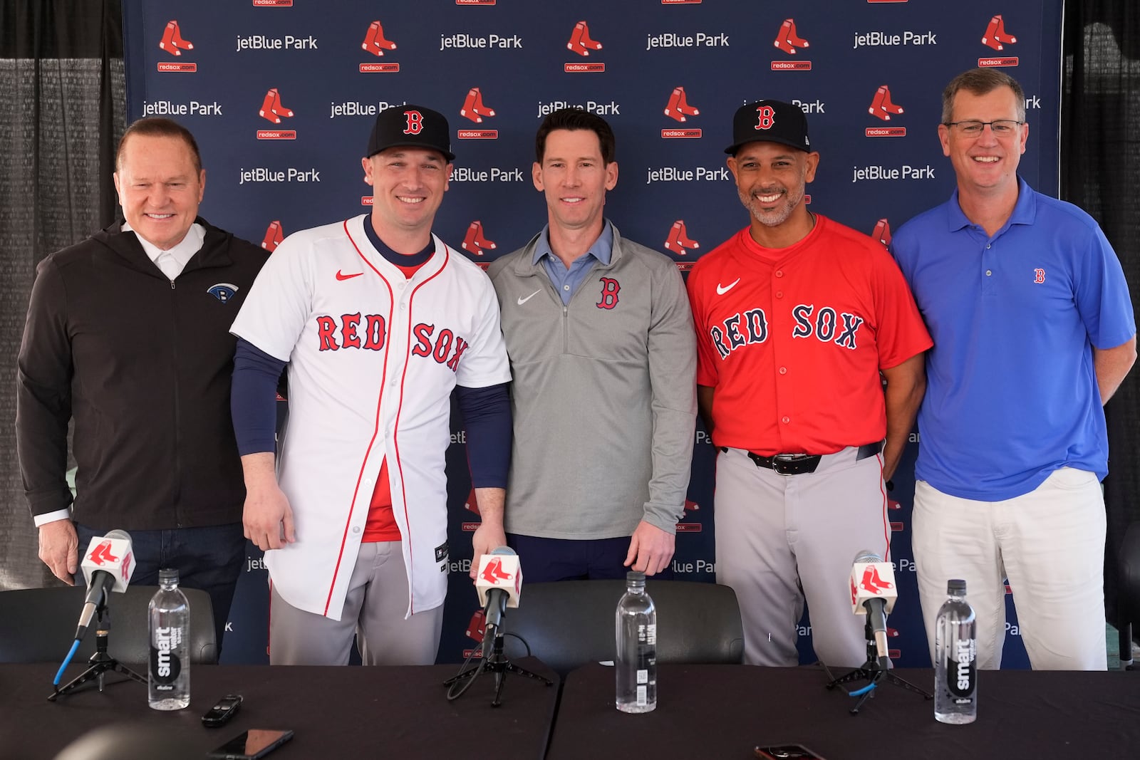 Alex Bregman, second left, poses with, left to right, with agent Scott Boras, Craig Breslow, chief baseball officer for the Boston Red Sox, manager Alex Cora and president and CEO Sam Kennedy, as he is introduced after signing a three year contract with the Red Sox in Fort Myers, Fla., Sunday, Feb. 16, 2025. (AP Photo/Gerald Herbert)