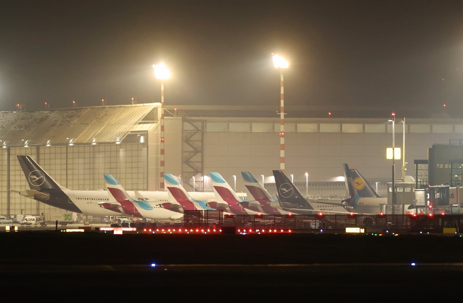 Aircraft are parked at the terminal building at D'sseldorf Airport, Germany early Monday, March 10, 2025. (Christoph Reichwein/dpa via AP)