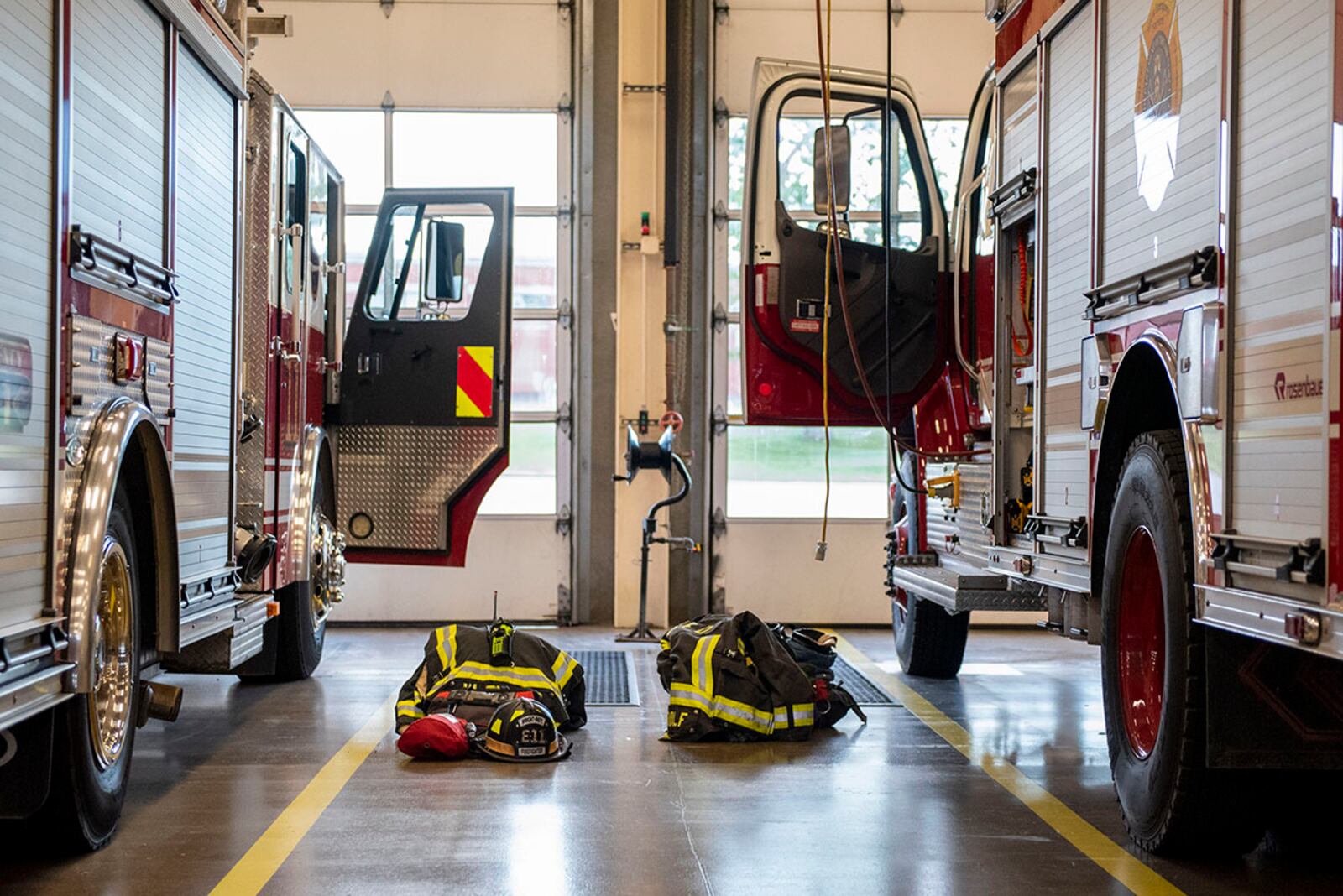 Bunker gear is staged next to two firetrucks June 23 inside bays at the 788th Civil Engineer Squadron Fire Department’s Station 1 on Wright-Patterson Air Force Base. U.S. AIR FORCE PHOTO/WESLEY FARNSWORTH