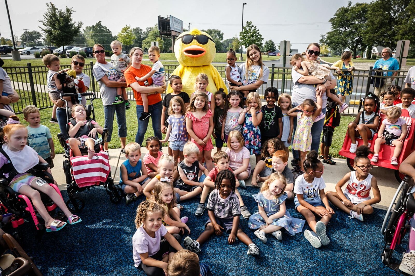 Children at the United Rehabilitation Services pose with Quackers the mascot for the Rubber Duck Regatta which is a fundraiser for the facility. The regatta will happen Saturday, Sept. 16, 2023 during the Hispanic Heritage Festival at RiverScape Metro Park. JIM NOELKER/STAFF