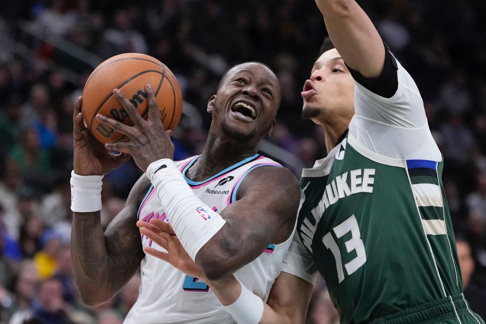 Miami Heat's Terry Rozier tries to get past Milwaukee Bucks' Ryan Rollins during the first half of an NBA basketball game Thursday, Jan. 23, 2025, in Milwaukee. (AP Photo/Morry Gash)