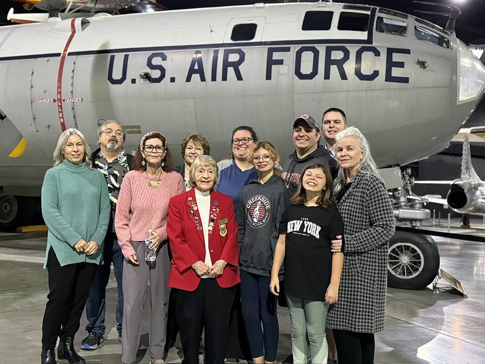 Cynthia Brubaker with her family at the National Aviation Heritage area 2024 Annual meeting, where she received the Ivonette Wright Miller Award honoring her for 50 years of volunteer service to the National Museum of the US Air Force. L-R Daughter Jenny Wohleb
Family friend Scott Hammond, daughter Anne Varvel, Cynthia, daughter Pat Zimmerman, Sarah Zimmerman, great granddaughter Lilly Zimmerman, grandson Andrew Zimmerman, great granddaughter Mackenzie Zimmerman, grandson Kyle Bumgardner and daughter Jill Brubaker.
