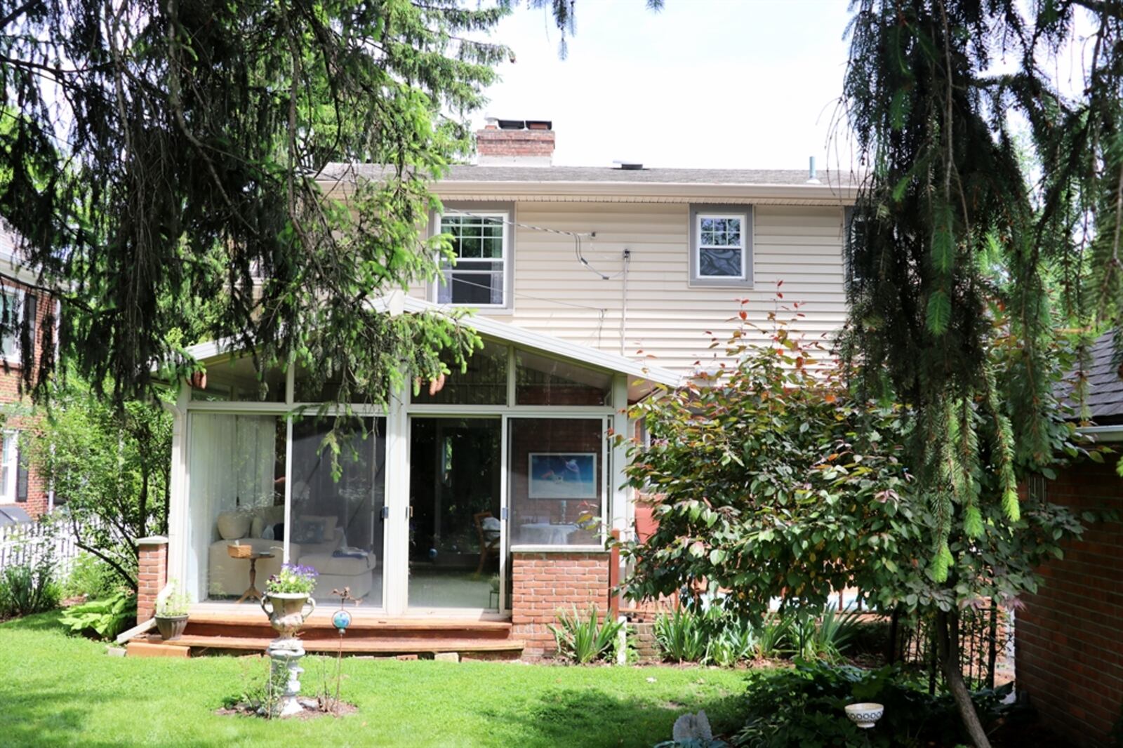 The sun room has panoramic views of the blooming, perennial garden within the semi-private backyard and access to a wooden sun deck. Contributed photo 