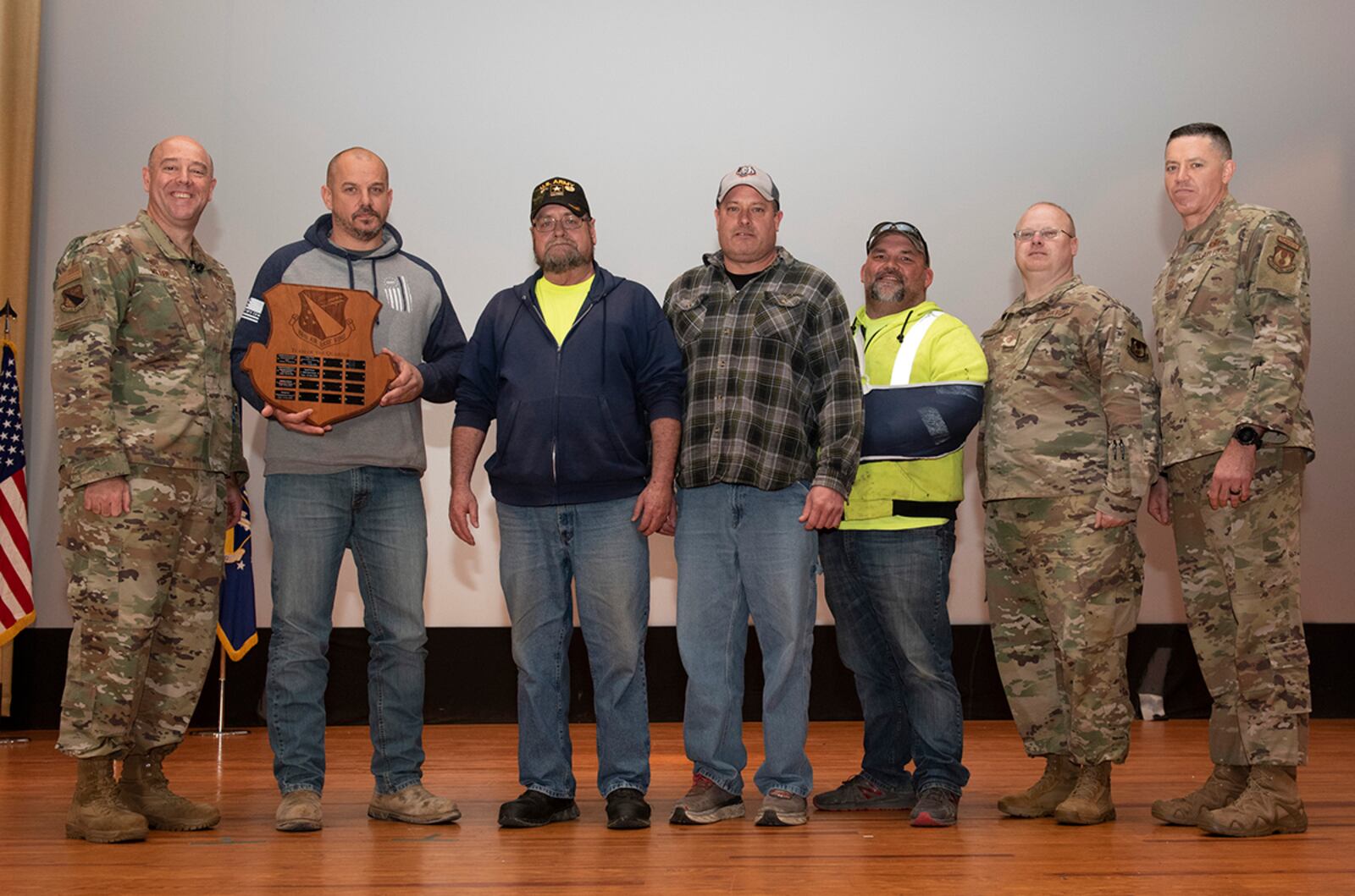 Col. Patrick Miller, 88th Air Base Wing and installation commander, and Chief Master Sgt. Jason Shaffer, 88th ABW command chief, present the 88th Civil Engineer Group snow and ice control team with an award on May 4. The snow and ice control team was selected as the 88th Air Base Wing large team winner for the first quarter. U.S. AIR FORCE PHOTO/JAIMA FOGG