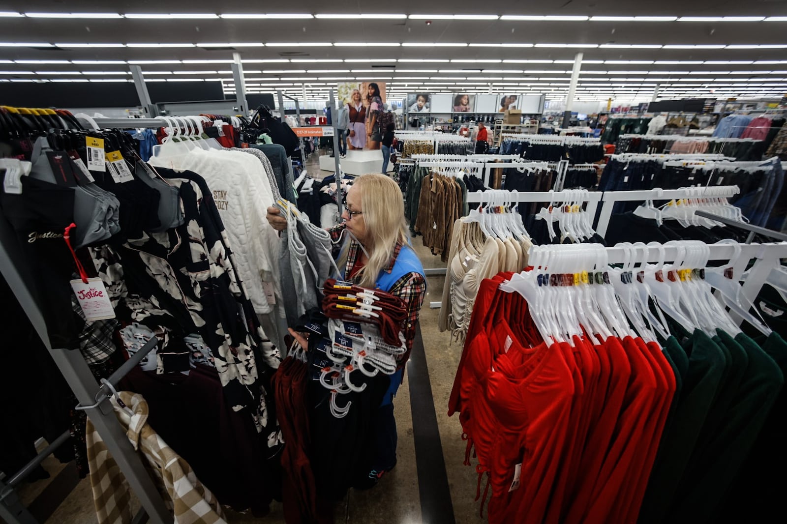 Angie Furlong restocks clothing at the Beavercreek Walmart Monday November 14, 2022. The Beavercreek Walmart is upgrading their store making it easier to find what customers are looking for. JIM NOELKER/STAFF