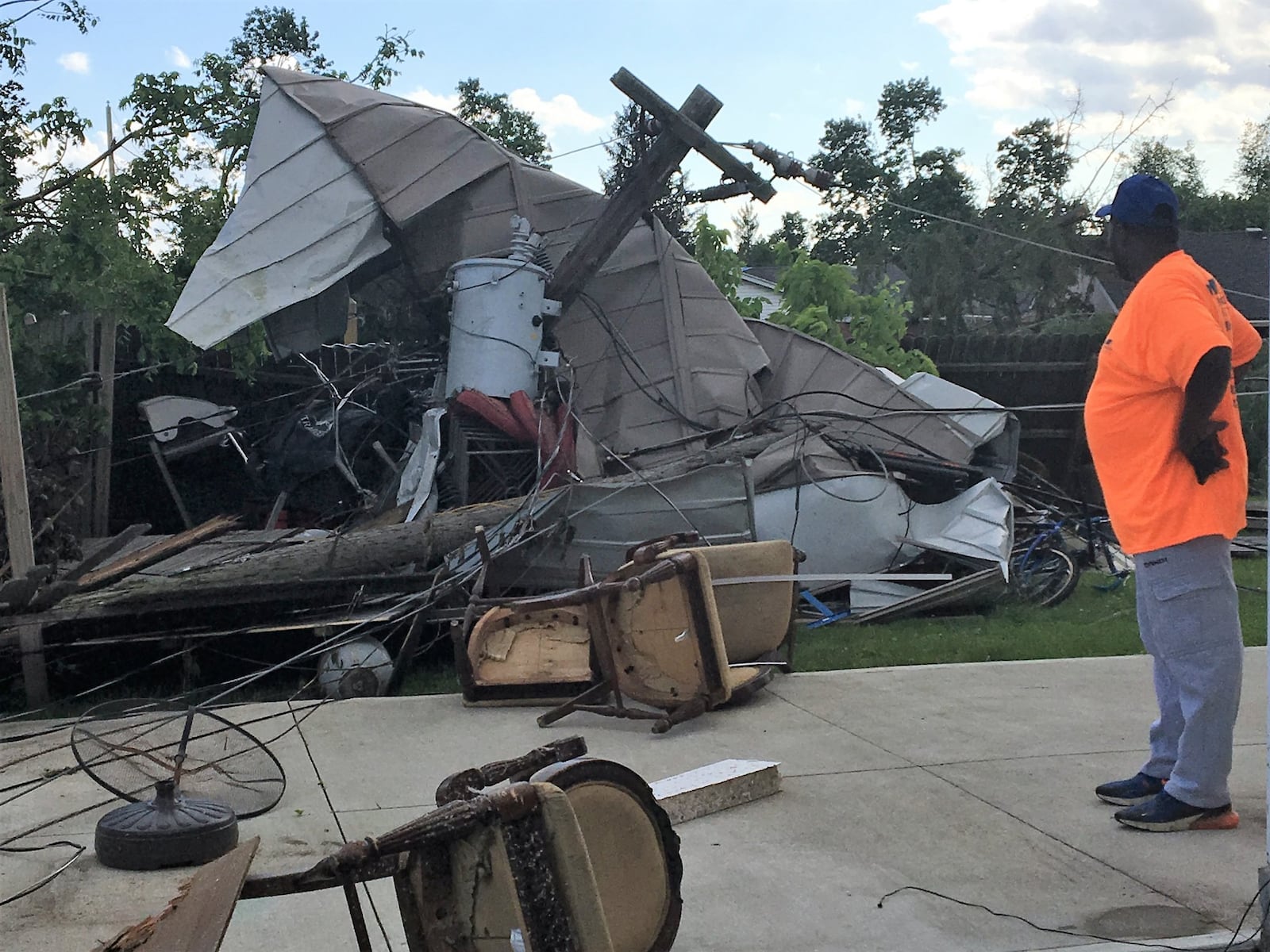 Jerome Ware looks at the mess of debris in his Trotwood backyard Thursday, May 30, 2019. KATIE WEDELL/STAFF